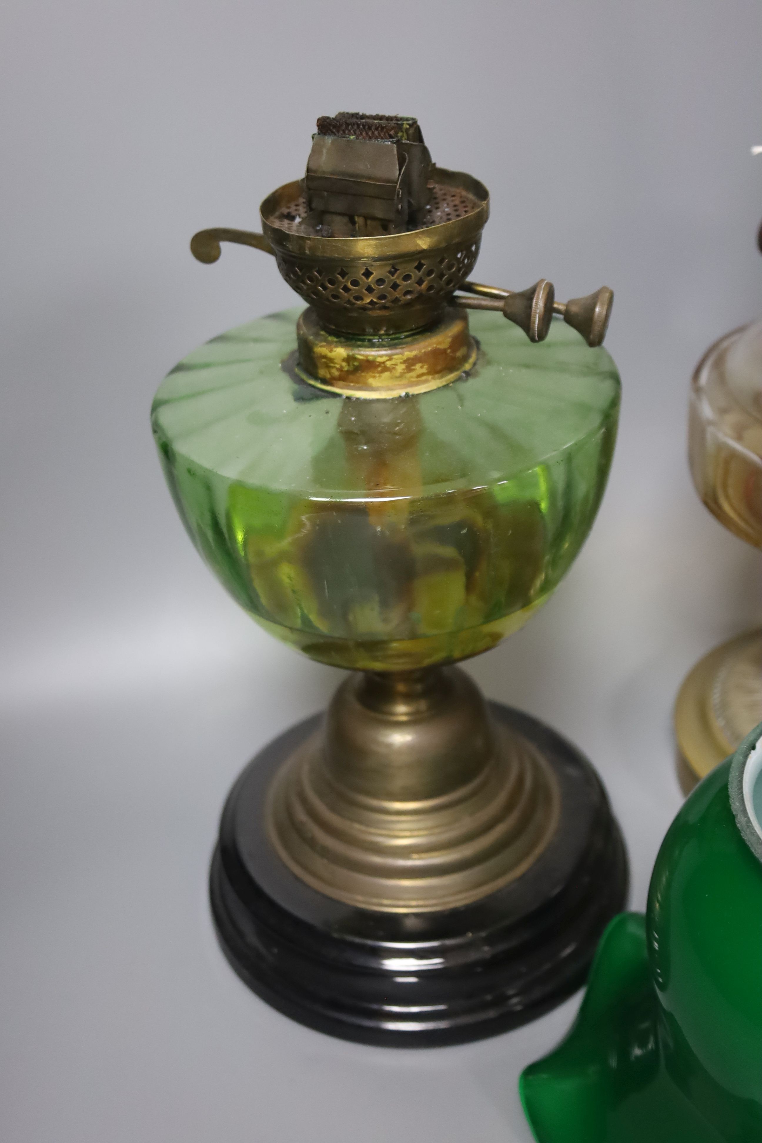 A brass green shade oil lamp and another oil lamp, 53cm